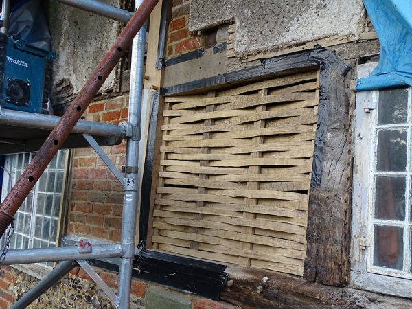 Wattle daub panels repair in progress
